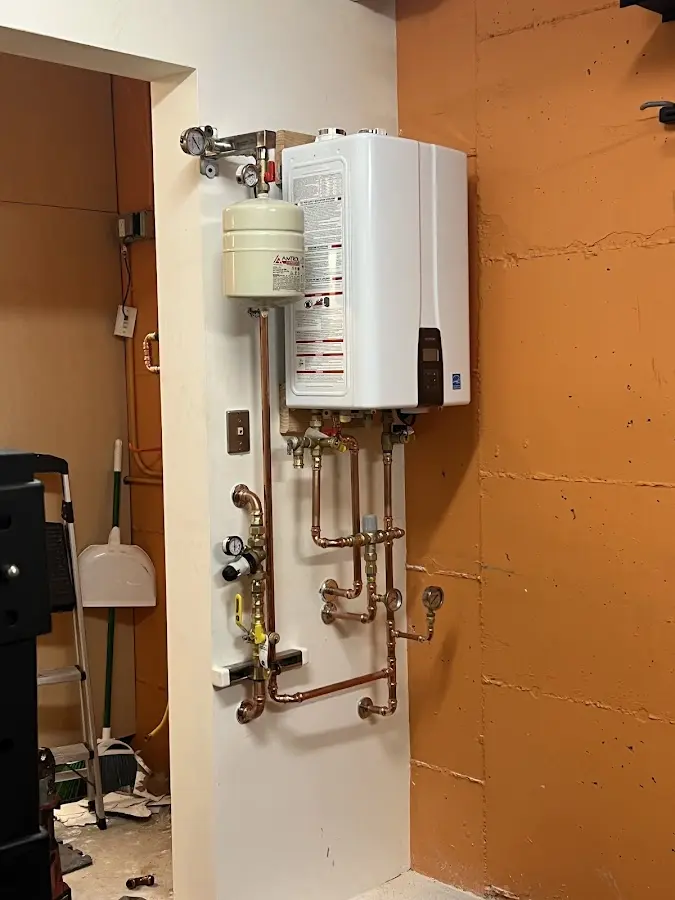 Plumbing technician inspecting water heater connections in Flagler Beach